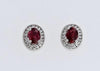 EARRINGS - 14K White Gold 6x4mm Oval Ruby And Diamond Halo Stud Earrings